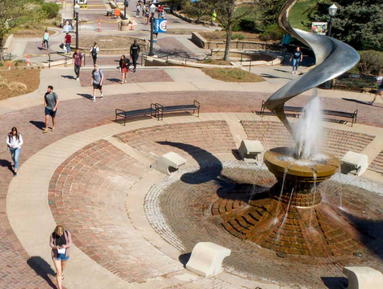 Creighton students walking by fountain on campus